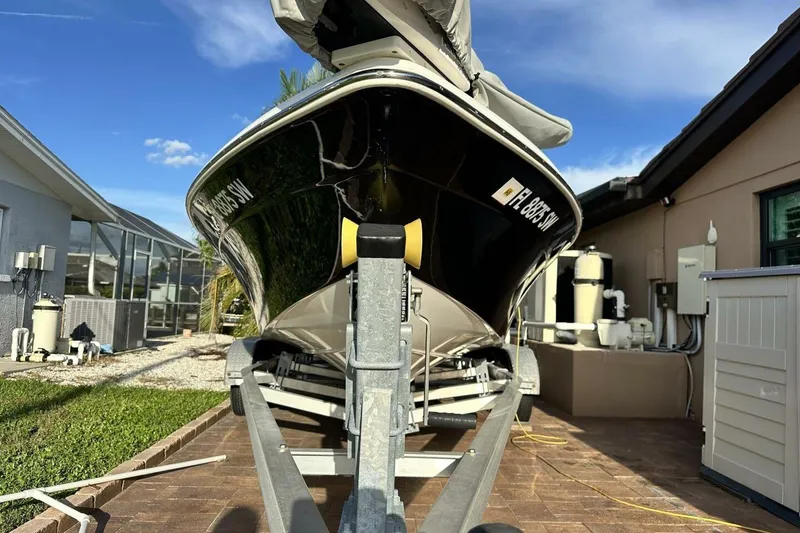 Slide: The Image of 2020 NauticStar 2140 Sport Shallow Bay boat on trailer, parked in residential driveway. - 27