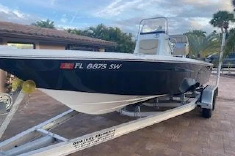 Slide: The Image of 2020 NauticStar 2140 Sport Shallow Bay boat on trailer, parked outdoors. - 3