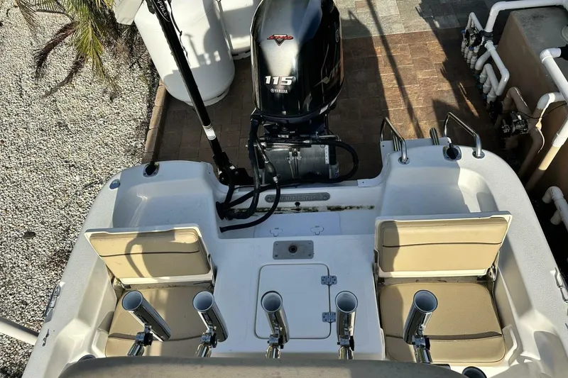 Slide: The Image of 2020 NauticStar 2140 Sport Shallow Bay boat with Yamaha 115 engine, rod holders, and seating. - 34