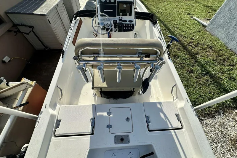 Slide: The Image of 2020 NauticStar 2140 Sport Shallow Bay boat interior with steering console and rod holders. - 36