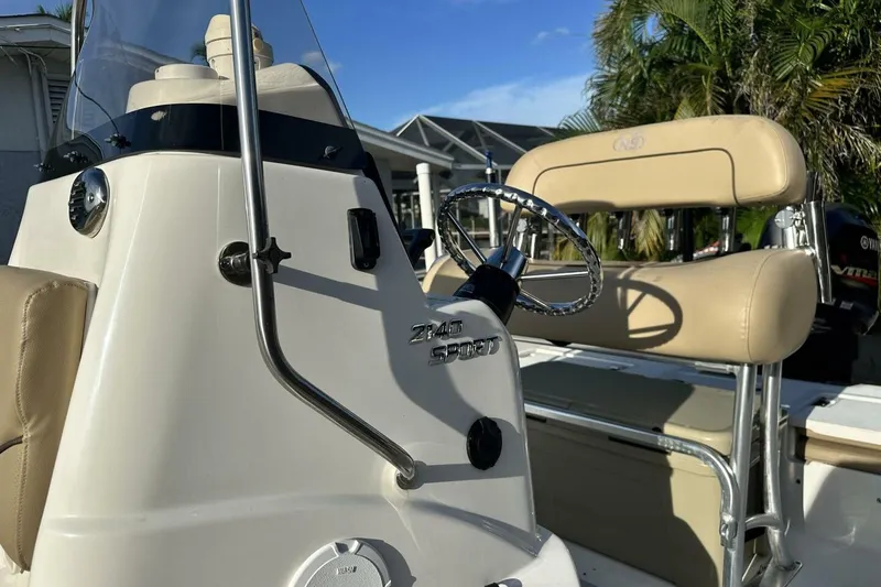 Slide: The Image of 2020 NauticStar 2140 Sport Shallow Bay boat interior with steering wheel and seating. - 37