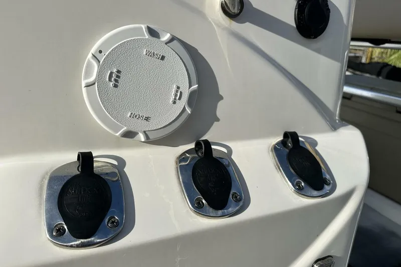 Slide: The Image of 2020 NauticStar 2140 Sport Shallow Bay boat controls and hose connections. - 38