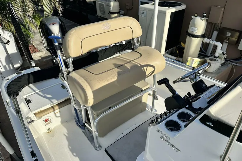 Slide: The Image of 2020 NauticStar 2140 Sport Shallow Bay boat interior with steering console and seating. - 40
