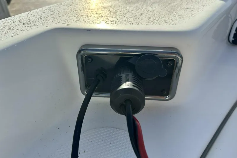 Slide: The Image of Close-up of a 2020 NauticStar 2140 Sport Shallow Bay boat's electrical outlet. - 41