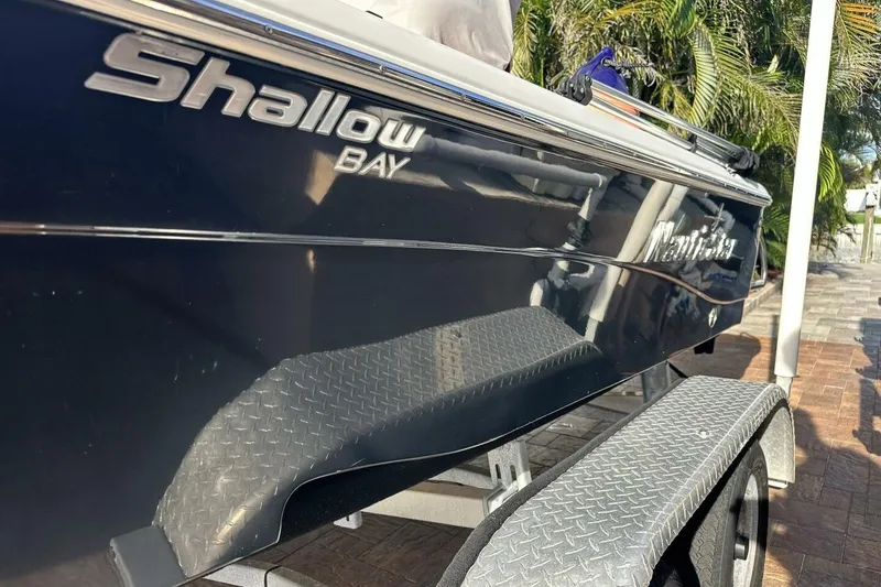 Slide: The Image of 2020 NauticStar 2140 Sport Shallow Bay boat on trailer, side view. - 48