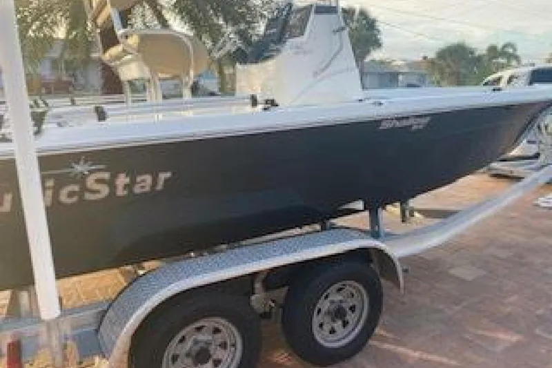 Slide: The Image of 2020 NauticStar 2140 Sport Shallow Bay boat on trailer, side view. - 5