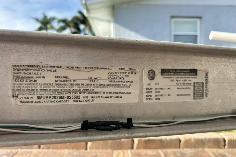 Slide: The Image of Label on a 2020 NauticStar 2140 Sport Shallow Bay trailer, detailing specifications and load capacity. - 51