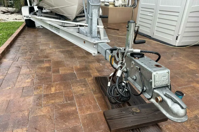 Slide: The Image of Trailer hitch of a 2020 NauticStar 2140 Sport Shallow Bay boat on a brick driveway. - 52