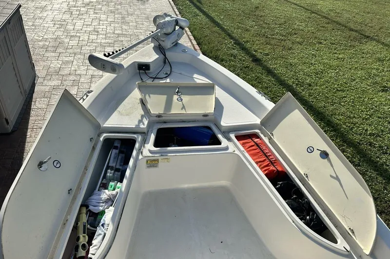 Slide: The Image of 2020 NauticStar 2140 Sport Shallow Bay boat with open storage compartments. - 7
