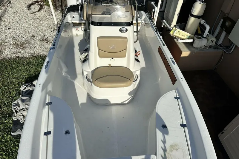 Slide: The Image of 2020 NauticStar 2140 Sport Shallow Bay boat interior with seating and console. - 8
