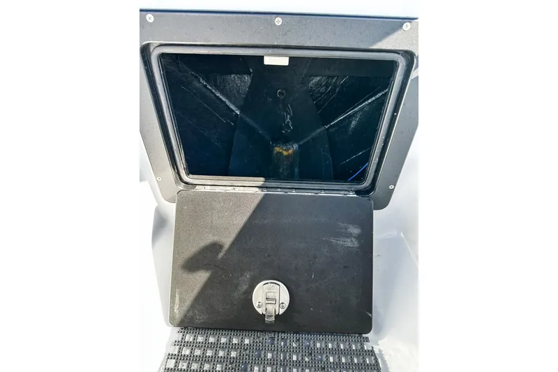Slide: The Image of 2020 East Cape Evo V boat storage compartment with secure latch. - 12
