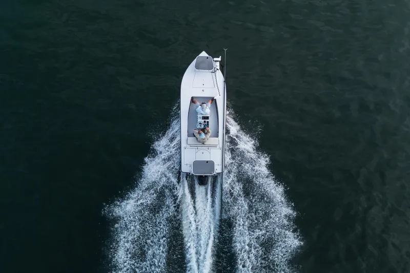 Slide: The Image of Aerial view of 2020 East Cape 18 EVO boat cruising on water. - 28