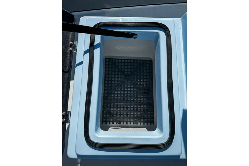 Slide: The Image of 2020 East Cape Evo V boat storage compartment with black grid mat. - 19