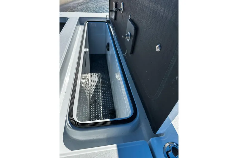 Slide: The Image of 2020 East Cape Evo V boat storage compartment with open lid, showcasing interior details. - 21