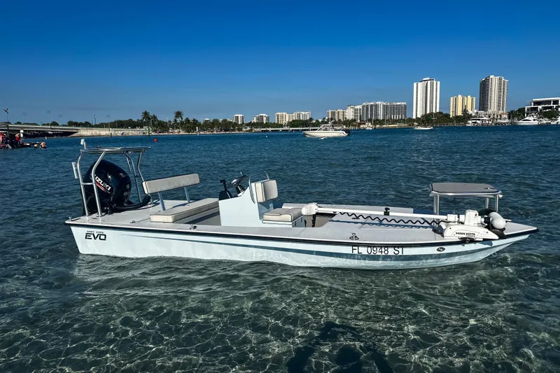 Slide: The Image of 2020 East Cape Evo V boat on clear water with city skyline background. - 23