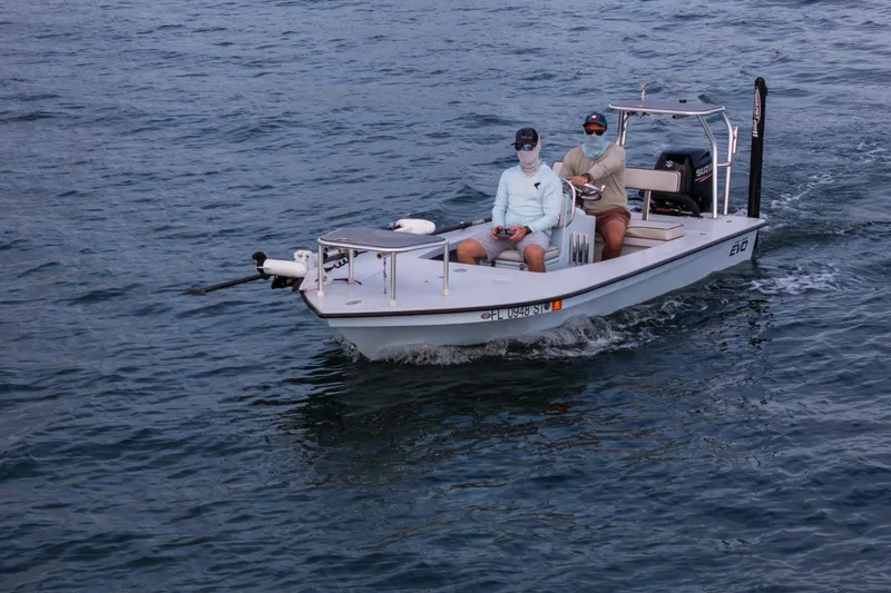 Slide: The Image of 2020 East Cape 18 EVO boat with two people navigating on open water. - 25
