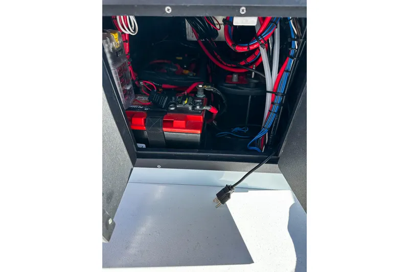 Slide: The Image of Electrical compartment of 2020 East Cape Evo V with wiring and battery setup. - 6