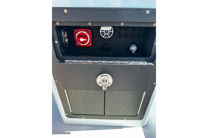 Slide: The Image of Control panel of a 2020 East Cape Evo V boat with switches and a red dial. - 7