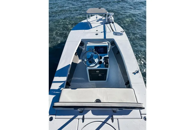 Slide: The Image of 2020 East Cape Evo V boat interior with steering wheel and seating on water. - 8