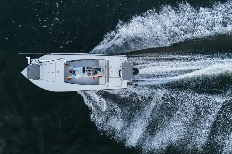 Slide: The Image of Aerial view of 2020 East Cape 18 EVO boat speeding on water, creating dynamic wake patterns. - 37