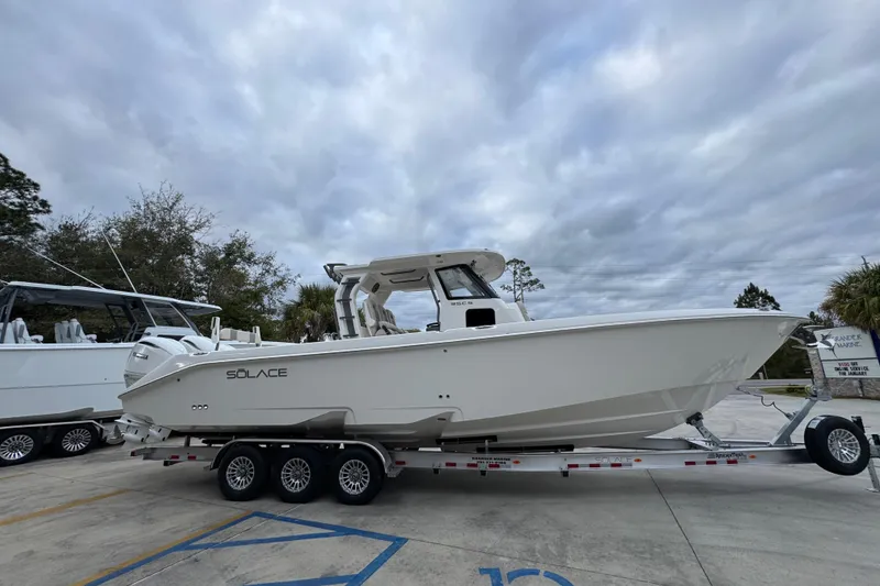Slide: The Image of 2026 Solace 35 CS boat on trailer under cloudy sky. - 10