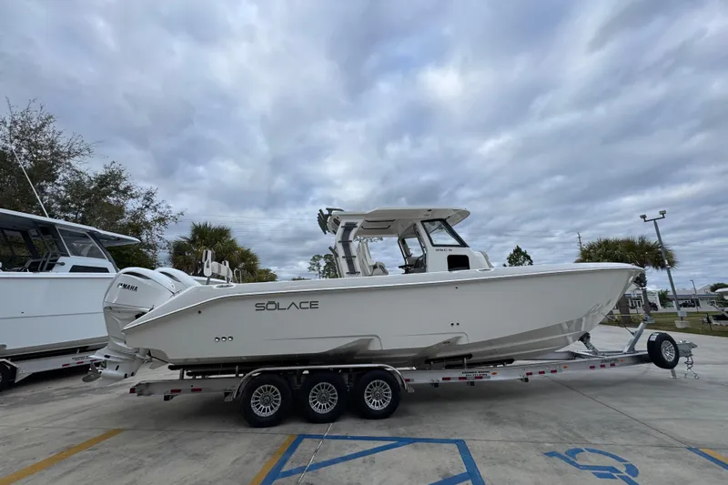 Slide: The Image of 2026 Solace 35 CS boat on trailer under cloudy sky. - 11