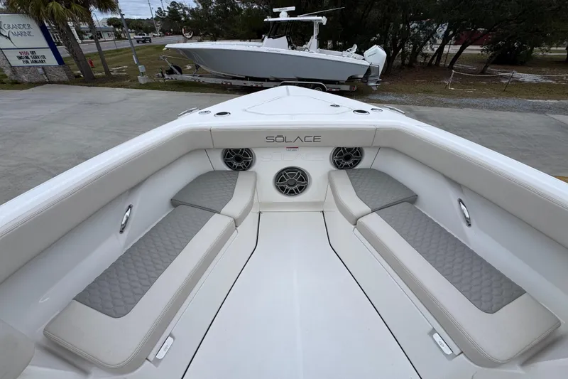 Slide: The Image of Interior view of 2026 Solace 35 CS boat with cushioned seating and speakers. - 20