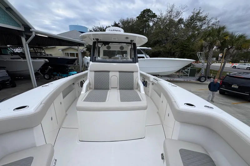 Slide: The Image of 2026 Solace 35 CS boat with cushioned seating, docked at a marina. - 24