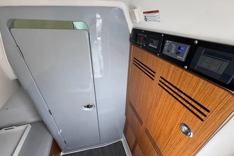 Slide: The Image of Interior of 2026 Solace 35 CS boat with control panel and wooden cabinetry. - 27