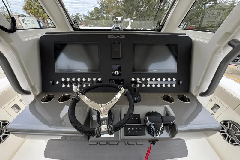 Slide: The Image of 2026 Solace 35 CS boat dashboard with dual screens and modern controls. - 39