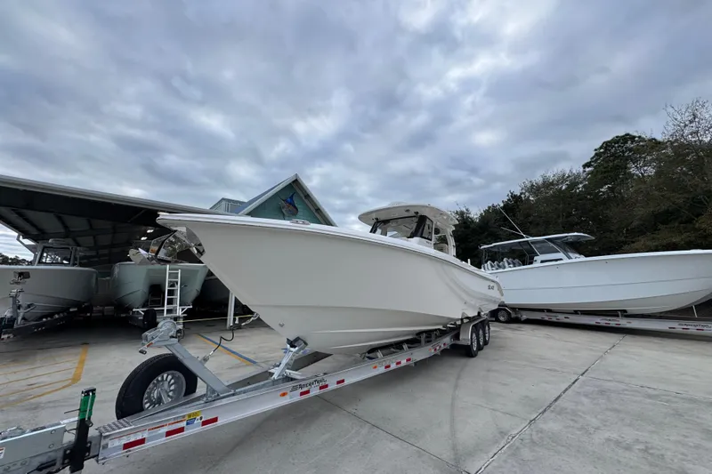 Slide: The Image of 2026 Solace 35 CS boat on trailer under cloudy sky at marina. - 4
