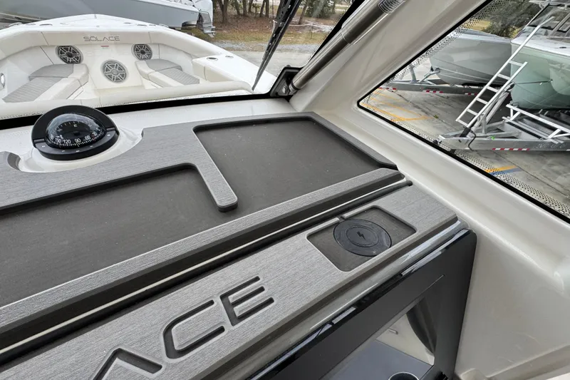 Slide: The Image of Interior view of 2026 Solace 35 CS boat dashboard with compass and seating area. - 42