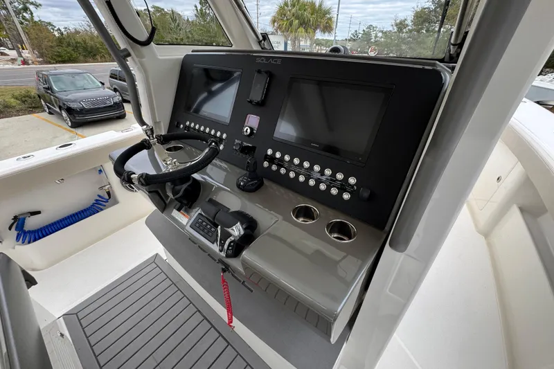 Slide: The Image of 2026 Solace 35 CS boat dashboard with dual screens and control panel. - 43