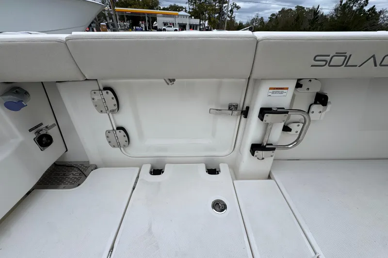 Slide: The Image of 2026 Solace 35 CS boat interior with seating and access door. - 47