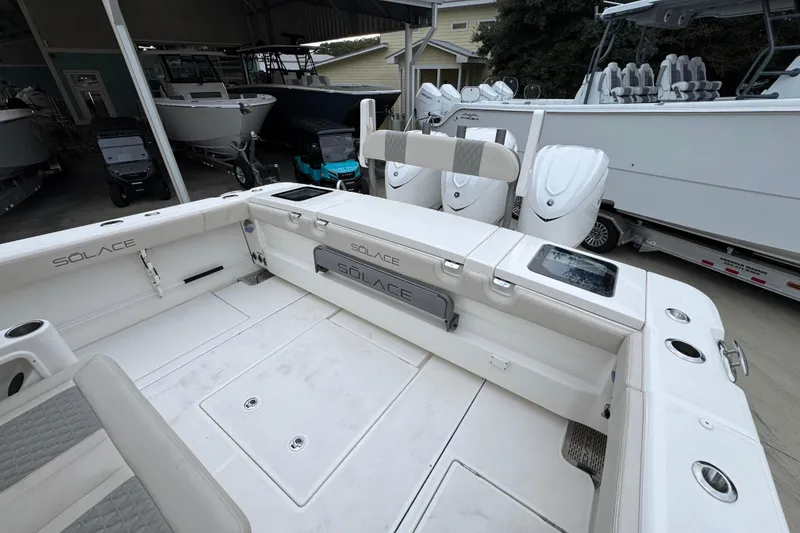 Slide: The Image of 2026 Solace 35 CS boat interior with seating and storage, displayed in a showroom. - 48