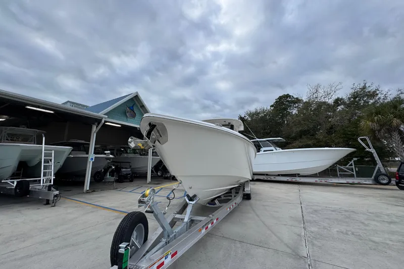 Slide: The Image of 2026 Solace 35 CS boat on trailer at marina under cloudy sky. - 5