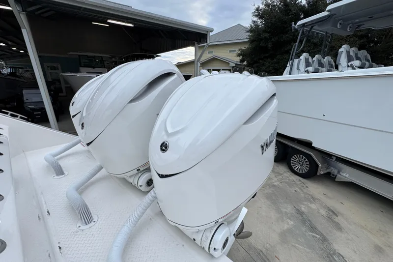 Slide: The Image of Twin outboard engines on a 2026 Solace 35 CS boat, parked in a marina. - 51