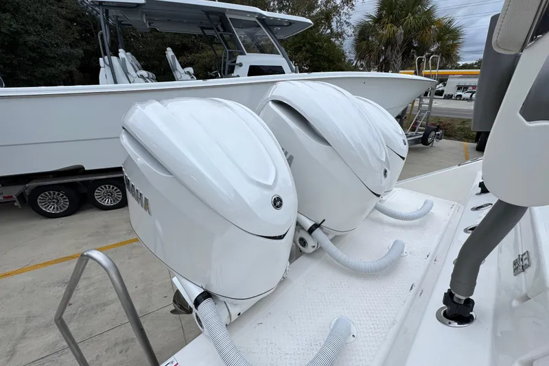 Slide: The Image of 2026 Solace 35 CS boat with dual Yamaha outboard engines, parked on a trailer. - 52