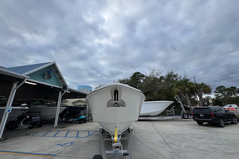 Slide: The Image of 2026 Solace 35 CS boat on trailer under cloudy sky at dealership. - 6
