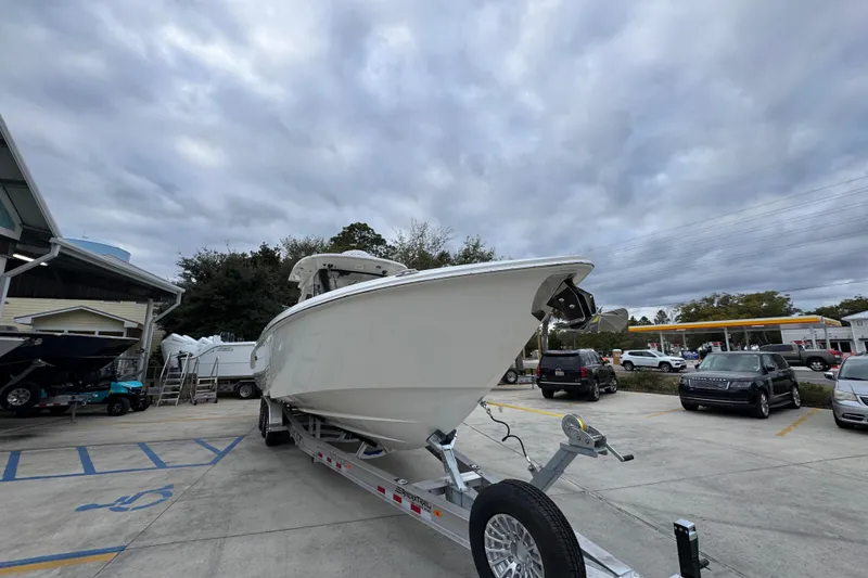 Slide: The Image of 2026 Solace 35 CS boat on trailer in parking lot under cloudy sky. - 7