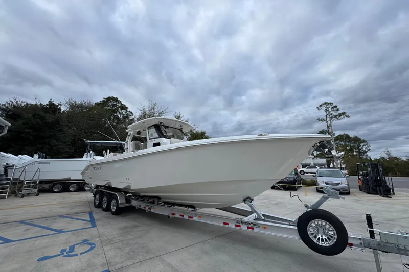 Slide: The Image of 2026 Solace 35 CS boat on trailer under cloudy sky in parking lot. - 8