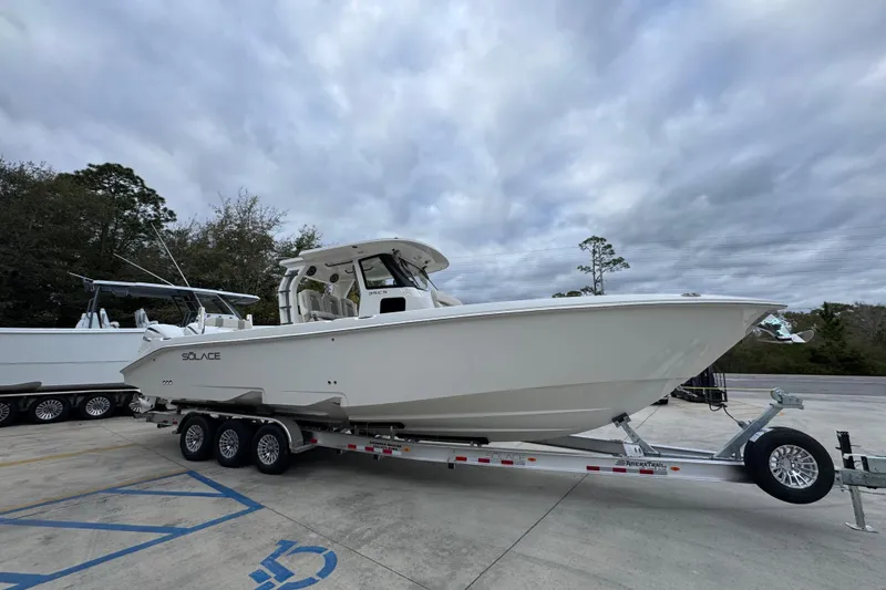 Slide: The Image of 2026 Solace 35 CS boat on trailer under cloudy sky. - 9