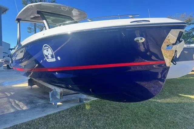 Slide: The Image of 2026 Monterey Elite 27 OB boat displayed outdoors under a cloudy sky. - 0