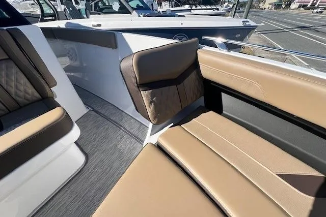 Slide: The Image of Luxurious cockpit of 2026 Monterey Elite 27 OB boat with modern steering and seating. - 15