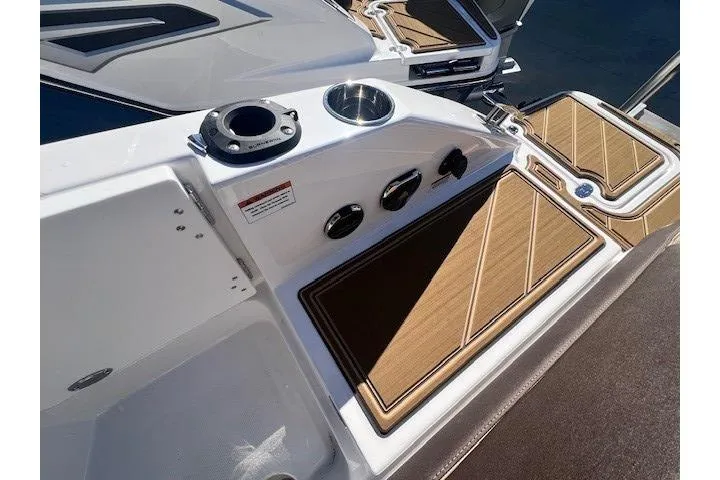 Slide: The Image of Control panel of 2026 Monterey Elite 27 OB boat with throttle and seating. - 17