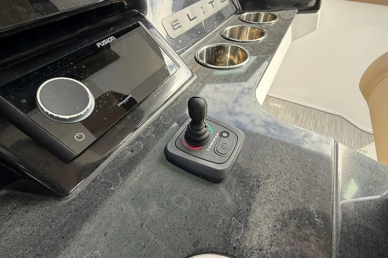 Slide: The Image of Control panel of 2026 Monterey Elite 27 OB boat with joystick and audio system. - 18