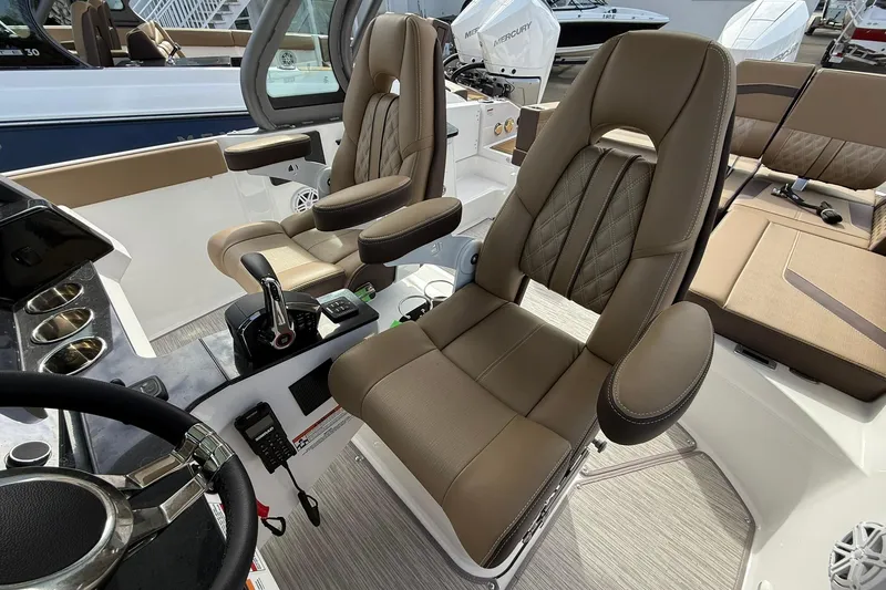 Slide: The Image of Luxury cockpit of 2026 Monterey Elite 27 OB boat with plush seating and controls. - 19