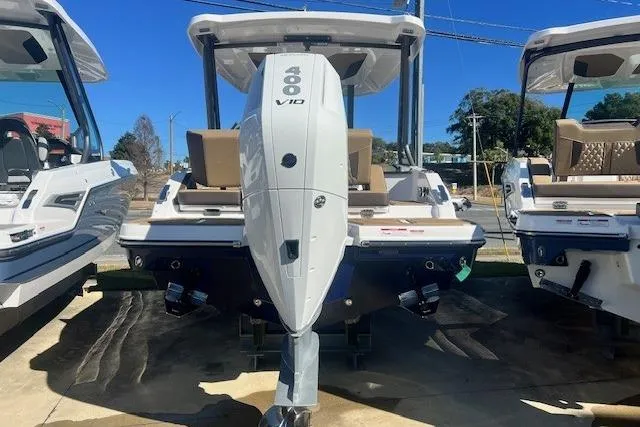 Slide: The Image of 2026 Monterey Elite 27 OB boat with Mercury outboard engine, docked outdoors. - 2