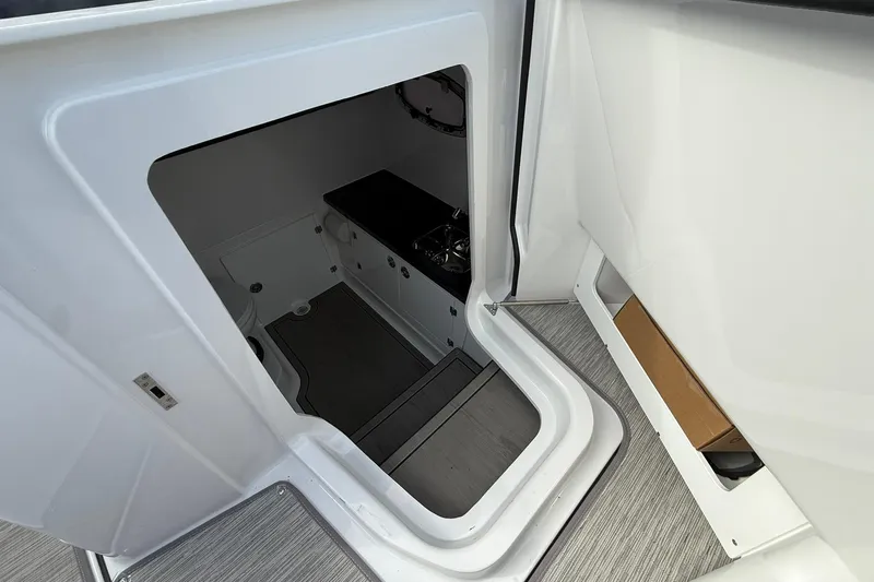 Slide: The Image of Interior view of 2026 Monterey Elite 27 OB boat cabin with sleek design. - 25