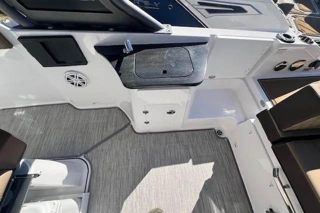 Slide: The Image of 2026 Monterey Elite 27 OB boat interior with tan seating and modern design. - 5